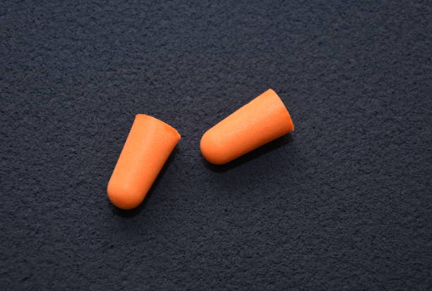 istock foam earplugs provide protection against harmful noise, orange  Protective earplugs 1251453379