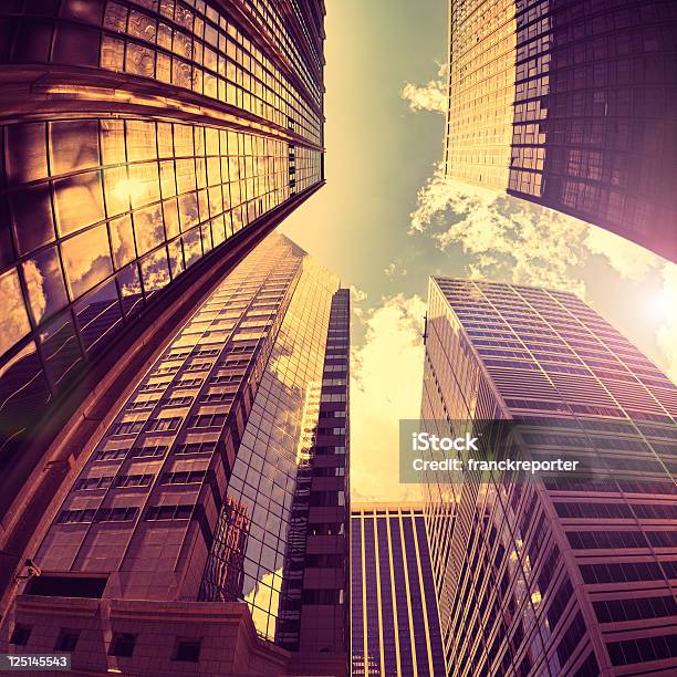 Alto Manhattan De Los Rascacielos De Oro Contra El Sol Foto de stock y más banco de imágenes de Rascacielos