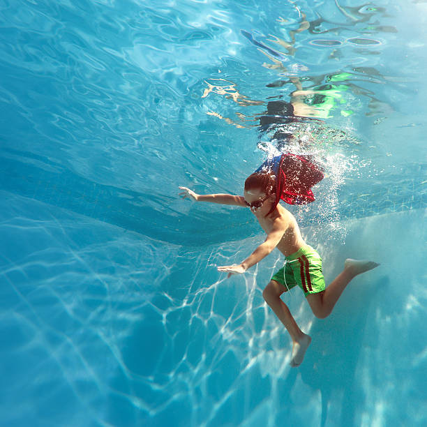 istock superhero boy swimming underwater 125145545