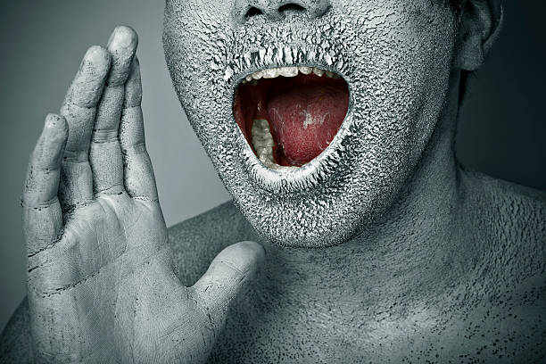 istock Close-up, chapped, dry painted human face screaming with open mouth 125145593