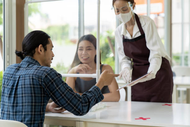 istock Asian waitress show menu with tablet. 1251456839