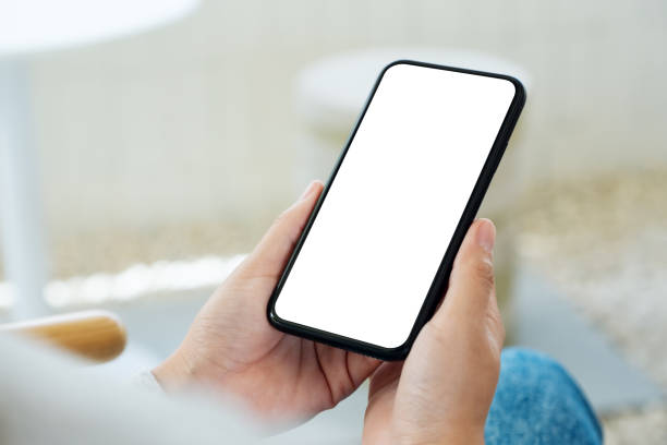 istock a woman holding mobile phone with blank white desktop screen 1251457077