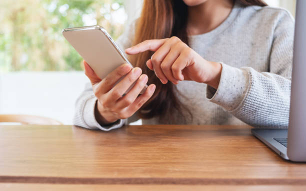 istock a woman holding and touching on mobile phone screen 1251457213