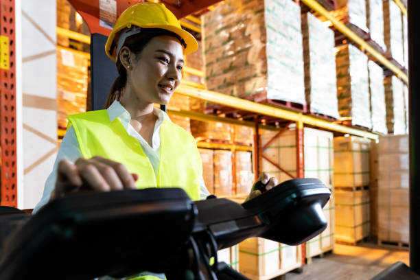 istock Asian warehouse worker with forklift in warehouse 1251457227