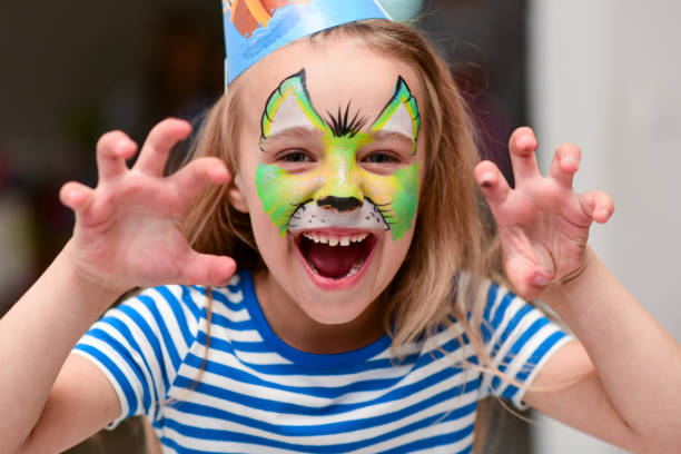 istock Child in makeup growls with claws hands 1251457939