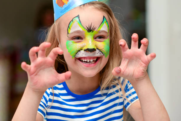 istock Child in makeup growls with claws hands 1251457942