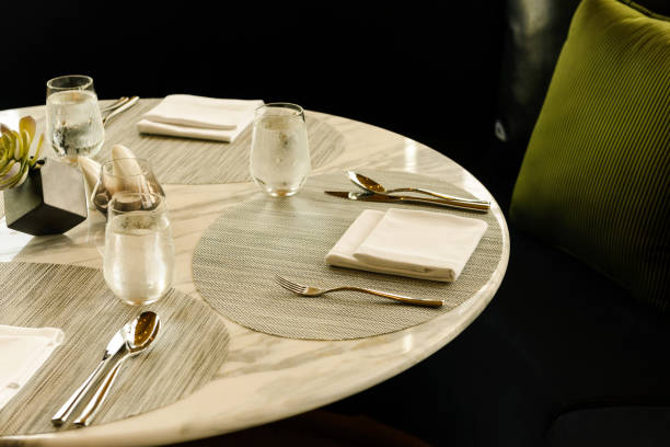 istock Tableware setting in the restaurant. Decorated elegant table, glasses, napkin, knife, fork and spoon 1251457951