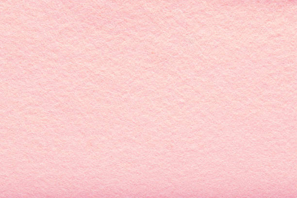 Fine grain pink woolen felt. Texture background. Velvet scarlet matte background of suede fabric stock photo
