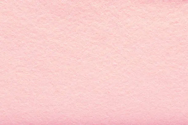 Photo of Fine grain pink woolen felt. Texture background. Velvet scarlet matte background of suede fabric