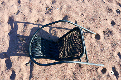 broken chair on sand