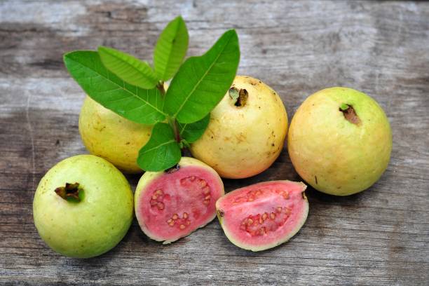 istock Red guava and green leaf on wooden table 1251459990