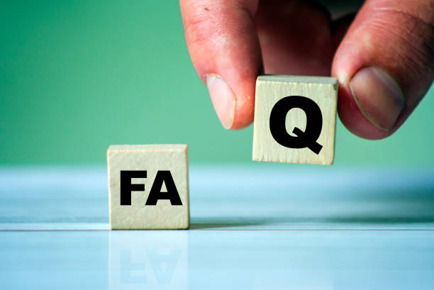 istock FAQ symbol. Word FAQ on wooden cube. Hand hold one cube. Frequently question site. 1251464825