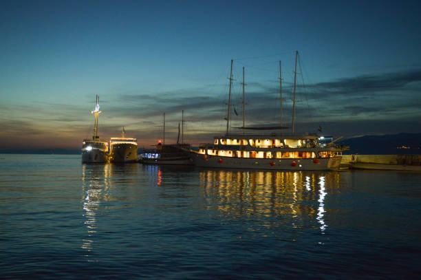 istock Ships in Postira harbor at dusk 1251470930