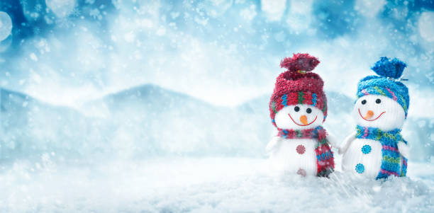 istock Two happy snowman hold hands in winter scenery Christmas background 1251471730