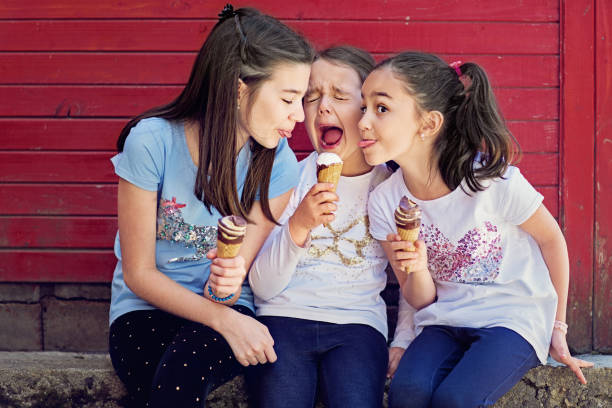 istock Girlfriends are eating ice cream and having fun together 1251474043