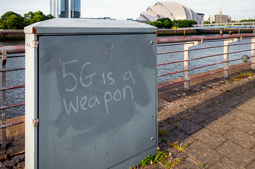 Glasgow, Scotland - A conspiracy theory slogan about 5G telecommunications networks, written on an equipment box in Glasgow.