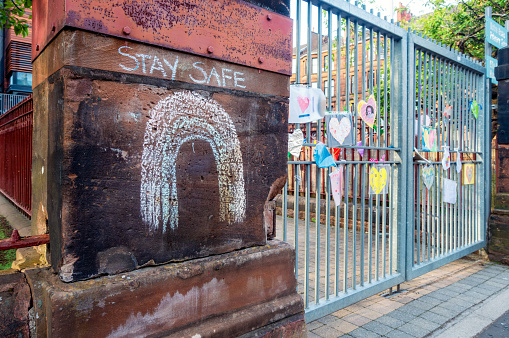 Glasgow, Scotland - Messages of support posted on the closed gates at Notre Dame school in Hyndland, with a 'Stay Safe' rainbow drawn in chalk on the stonework.