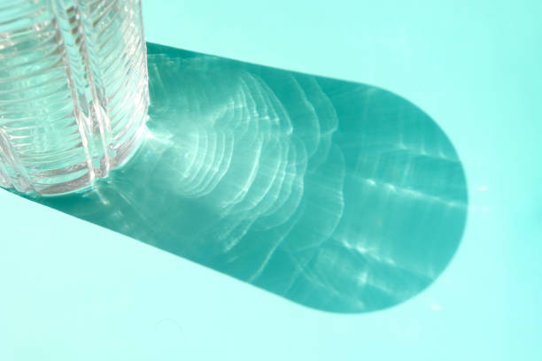 istock Trend shadow from a crystal vase on a blue background 1251476654
