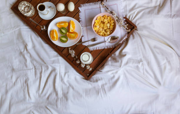 Romantic Breakfast in bed with spring flowers. Flat lay, copy space stock photo