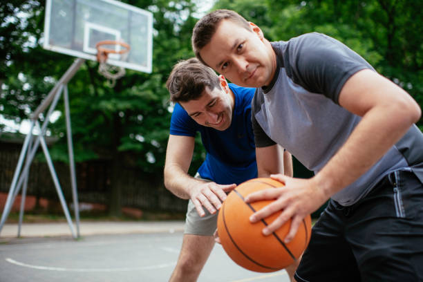 istock Close up of hands holding ball. 1251477035