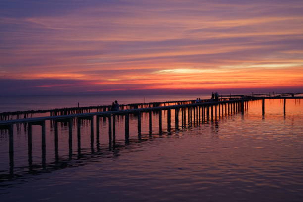 istock SunSet and Twilight Sky at Red Boardwalk Bridge 1251477263