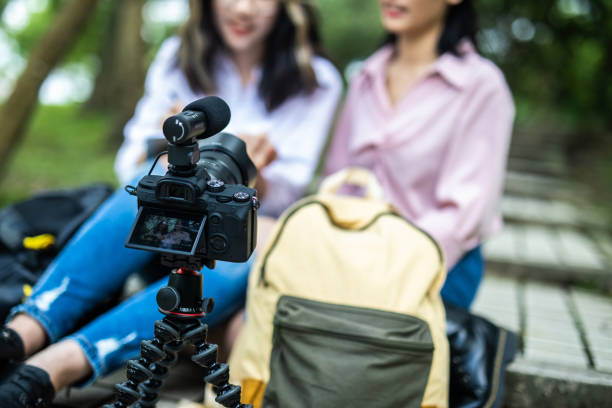istock Friends relaxing after class in public park and vlogging about education 1251479128