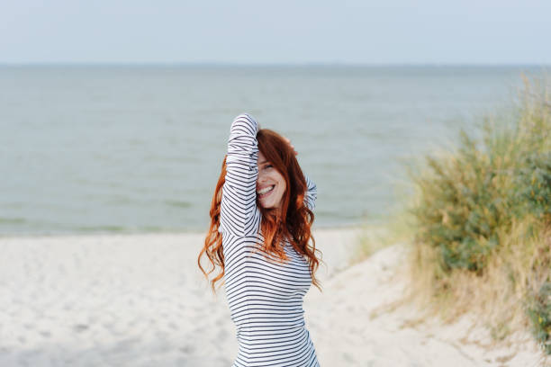 istock Mischievous young woman peeping at the camera 1251481625
