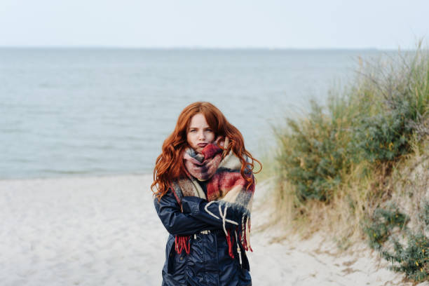 istock Unimpressed young woman shivering in the cold 1251481738
