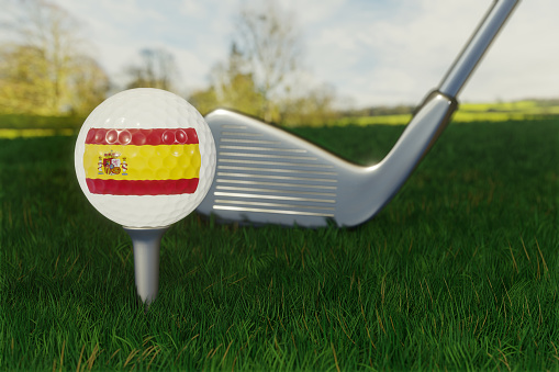 Concept of golf in Spain with the national flag on a golf ball.