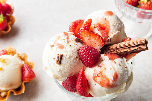 Vanilla Ice Cream Scoops with strawberry pieces, easy dessert at home