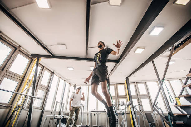 istock One man volleyball player training in the gym with a personal trainer 1251481930