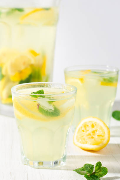 istock Two glasses of lemonade on the white table. 1251482261