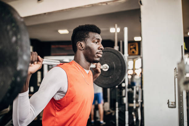 istock Man volleyball player training with weights in the gym 1251482891