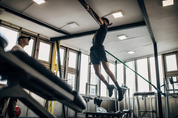 istock Man volleyball player training in the gym with a personal trainer 1251483108