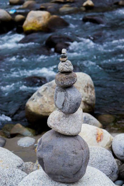 istock Rock Balancing having flowing river in the background 1251483524