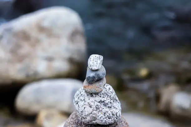 Photo of Rock Balancing having flowing river in the background