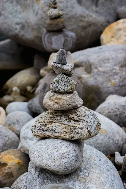 Photo of Rock Balancing having flowing river in the background