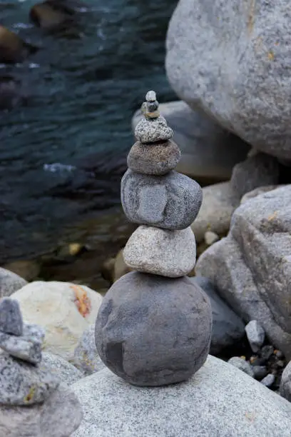 Photo of Rock Balancing having flowing river in the background