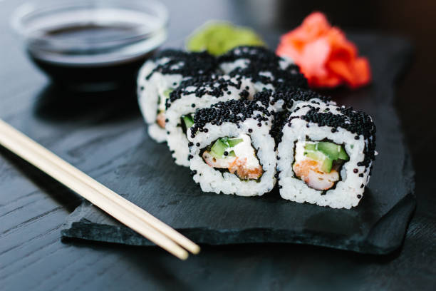 istock Sushi roll with black caviar on a slate plate 1251486467