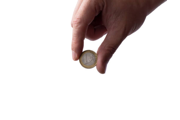 istock One euro coun  in hand on white background. Isolated with copy space. Crisis concept. 1251486870