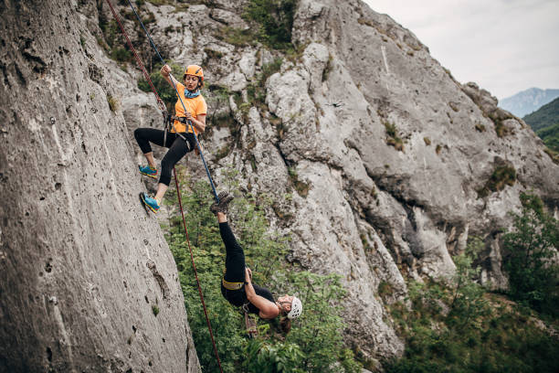 istock Women free climbers climbing on the rock mountain 1251487505