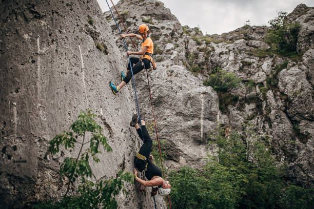 istock Two female free climbers climbing on the rock 1251488644