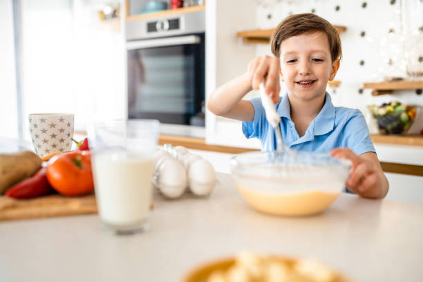 istock Happy beautiful kid learn preparing breakfast at home kitchen 1251488656