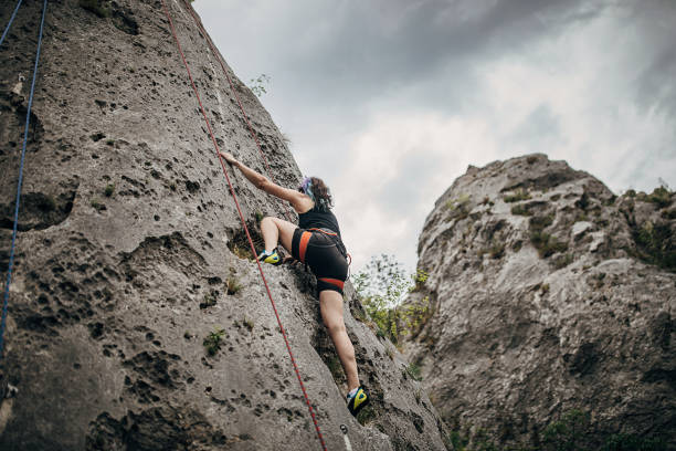 istock One strong climber woman climbing on the rock 1251489515