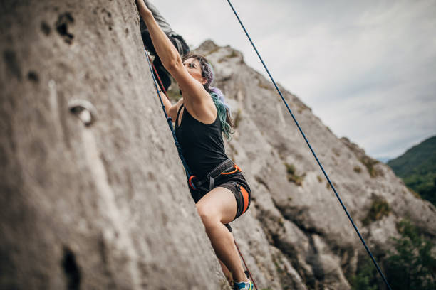 istock One climber woman climbing on the rock 1251489630
