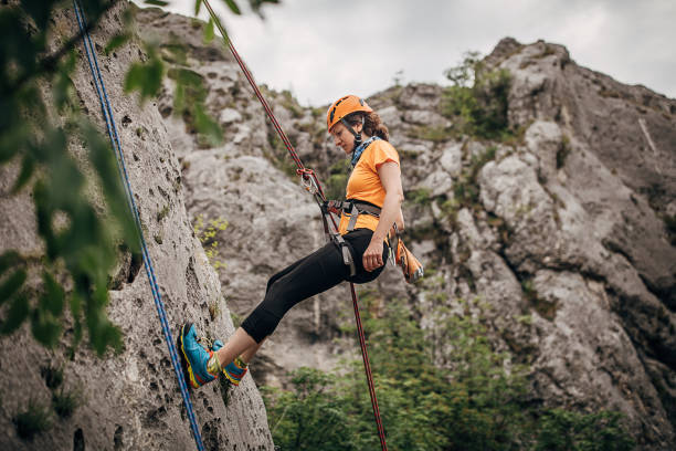 istock One athletic woman climbing on the rock 1251489733