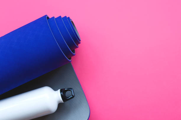 istock Bright blue yoga mat on a pink background 1251491599