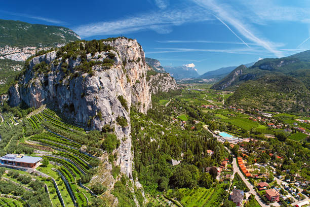 Landscape - valley with village among mountains, high mountain with vineyards Landscape - valley with village among mountains, high mountain with vineyards near lake Lago di Garda, Italy trentino south tyrol stock pictures, royalty-free photos & images