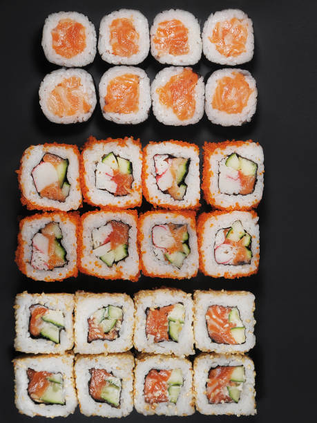 istock Japanese rolls on black stone background. 1251492798
