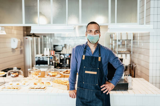 istock Essential worker in bakery or cafe, smiling under the mask 1251492816